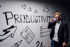 Image of productivity on the wall with a man on the phone